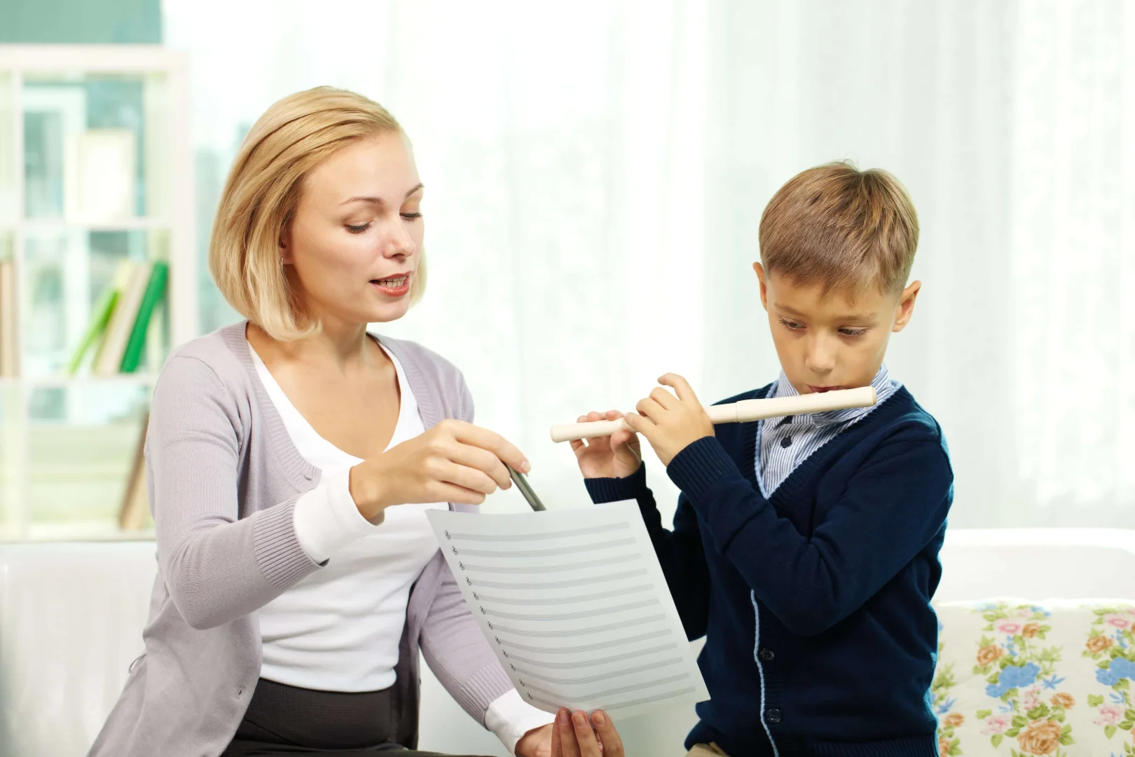 Instructor teaching her student Flute lessons